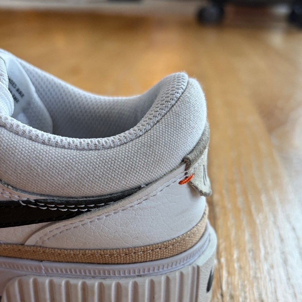 Nike White Low-Top Sneakers with Black Swoosh and Gold Accent - Picture 13 of 15